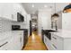 Modern kitchen featuring white cabinets, stainless steel appliances, and a black faucet at 2715 Memorial Se Dr, Atlanta, GA 30317