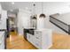 Modern kitchen featuring white cabinets, black appliances, and an island with seating at 2715 Memorial Se Dr, Atlanta, GA 30317