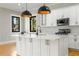 Modern kitchen island with white cabinets, quartz countertops, and pendant lighting at 2715 Memorial Se Dr, Atlanta, GA 30317