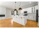 Spacious kitchen boasts white cabinets, a center island, and stainless steel appliances at 2715 Memorial Se Dr, Atlanta, GA 30317