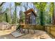 Fun backyard play area with a playhouse, slide, storage shed, and animal enclosure at 2715 Memorial Se Dr, Atlanta, GA 30317