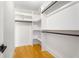 Walk-in closet with custom shelving and hardwood floors at 2715 Memorial Se Dr, Atlanta, GA 30317