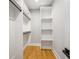 Walk-in closet with custom shelving and hardwood floors at 2715 Memorial Se Dr, Atlanta, GA 30317