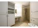 Main bathroom with walk-in shower and built-in shelving at 780 Navajo Trl, Covington, GA 30016