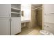 Accessible bathroom with roll-in shower and built-in cabinets at 780 Navajo Trl, Covington, GA 30016