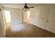 Spacious bedroom featuring neutral carpet, a ceiling fan, and access to an ensuite bathroom at 780 Navajo Trl, Covington, GA 30016