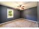 Simple bedroom with ceiling fan and carpeting at 780 Navajo Trl, Covington, GA 30016