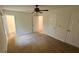 Spacious bedroom featuring neutral carpet, a ceiling fan, and access to an ensuite bathroom at 780 Navajo Trl, Covington, GA 30016