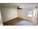 Bedroom with ceiling fan and window overlooking backyard at 780 Navajo Trl, Covington, GA 30016