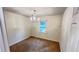 Well-lit bedroom with neutral walls, carpet floors, and a hanging chandelier light fixture at 780 Navajo Trl, Covington, GA 30016