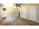 Main bedroom with carpet, ceiling fan, and multiple closets at 780 Navajo Trl, Covington, GA 30016