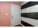 Interior entryway with pink walls and black and white striped wall at 780 Navajo Trl, Covington, GA 30016