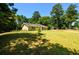 Green house with mature trees and grassy lawn at 780 Navajo Trl, Covington, GA 30016