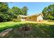 View of the back of the house showcasing a large yard at 780 Navajo Trl, Covington, GA 30016