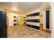 Kitchen with tile floor, wood cabinets, and black and white wall at 780 Navajo Trl, Covington, GA 30016