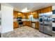 Kitchen with wood cabinets, stainless steel appliances, and tile floor at 780 Navajo Trl, Covington, GA 30016