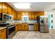 Well-lit kitchen with stainless steel appliances, plentiful cabinet space, and modern backsplash at 780 Navajo Trl, Covington, GA 30016