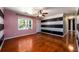 Living room with hardwood floors, pink walls and a window at 780 Navajo Trl, Covington, GA 30016