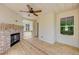 Covered back porch with built-in brick fireplace and ceiling fan at 105 Eryn Ter, Covington, GA 30014
