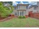 Landscaped backyard featuring a well maintained lawn, privacy fence and partial patio at 1125 Blackshear Dr, Decatur, GA 30033