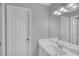 Bright bathroom featuring a white marble vanity, modern fixtures, and a large mirror at 1125 Blackshear Dr, Decatur, GA 30033