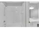 Bright bathroom featuring white tile shower, modern fixtures, and a large mirror at 1125 Blackshear Dr, Decatur, GA 30033