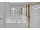 Bright bathroom showcasing a glass block window above the tub and gold trim shower at 1125 Blackshear Dr, Decatur, GA 30033