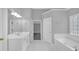 Bright main bathroom with double sinks, tub, and plenty of storage at 1125 Blackshear Dr, Decatur, GA 30033