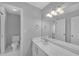 Clean bathroom with white marble vanity, modern lighting, toilet, and a large mirror at 1125 Blackshear Dr, Decatur, GA 30033