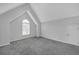 Bedroom features neutral walls, vaulted ceilings, gray carpet, and natural light from large window at 1125 Blackshear Dr, Decatur, GA 30033