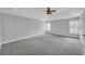 Spacious bedroom with a tray ceiling, neutral walls, and carpeted floors at 1125 Blackshear Dr, Decatur, GA 30033