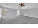 A carpeted primary bedroom with a ceiling fan, neutral paint, large windows and attached bathroom at 1125 Blackshear Dr, Decatur, GA 30033