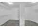 Walk-in closet featuring carpeted floors and wire shelving for organized storage at 1125 Blackshear Dr, Decatur, GA 30033