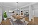 Open-concept dining room with hardwood floors and a modern chandelier at 1125 Blackshear Dr, Decatur, GA 30033