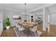 Open concept dining room featuring hardwood floors, modern chandelier, and neutral paint tones at 1125 Blackshear Dr, Decatur, GA 30033