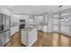 Bright kitchen featuring stainless steel appliances, white cabinets, granite countertops and hardwood floors at 1125 Blackshear Dr, Decatur, GA 30033