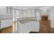 Open kitchen with granite countertops, white cabinetry, stainless steel appliances, and hardwood floors at 1125 Blackshear Dr, Decatur, GA 30033