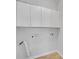A bright laundry room boasts ample overhead storage for organization at 1125 Blackshear Dr, Decatur, GA 30033