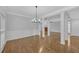 Open-concept living room with hardwood floors, elegant columns, and fireplace view at 1125 Blackshear Dr, Decatur, GA 30033