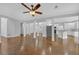 Open-concept living room with hardwood floors, white pillars, and a view into the kitchen at 1125 Blackshear Dr, Decatur, GA 30033