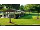 Exterior shot of a park pavillion surrounded by lush green grass and mature trees at 1125 Blackshear Dr, Decatur, GA 30033
