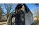 Damaged area on the rear of the house, with a staircase, siding, and boarded-up windows at 1193 Meadow Oaks Nw Dr, Acworth, GA 30102