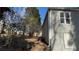 Shows the home's backyard and damaged exterior with a boarded window and a pathway at 1193 Meadow Oaks Nw Dr, Acworth, GA 30102