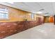 Unfinished basement with exposed brick and wood paneling offers renovation potential at 380 Stone Rd, Mcdonough, GA 30253
