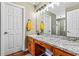 Bathroom features vanity with granite countertop and framed mirror, plus storage cabinets at 380 Stone Rd, Mcdonough, GA 30253