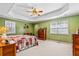 Spacious bedroom features tray ceilings, neutral carpeting, and lots of natural light at 380 Stone Rd, Mcdonough, GA 30253