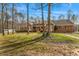 Charming brick home with a lush front lawn surrounded by mature trees at 380 Stone Rd, Mcdonough, GA 30253