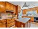 Well-lit kitchen featuring custom wood cabinetry, modern appliances, and a center island at 380 Stone Rd, Mcdonough, GA 30253