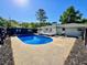 Large backyard featuring an in-ground pool, patio area, small deck, and outdoor seating with a grill at 4 Crestwood Rd, Cartersville, GA 30121