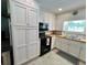 Kitchen boasting white cabinets, butcher block countertops, and black appliances at 4 Crestwood Rd, Cartersville, GA 30121